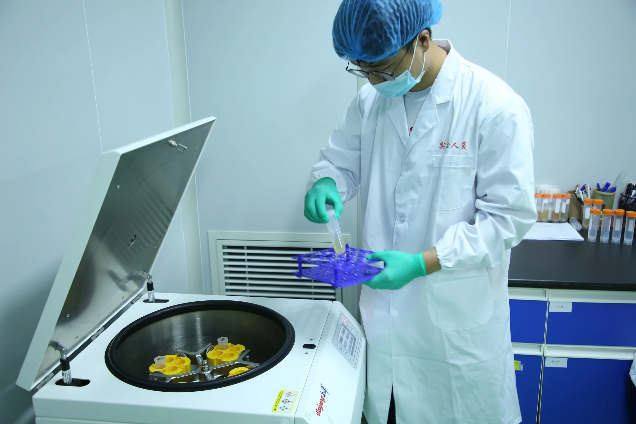 Laboratory worker using a centrifuge for sample processing